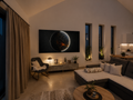 Impact of Greed illuminated relief artwork by Project X displayed in a contemporary living room with warm ambient lighting.
