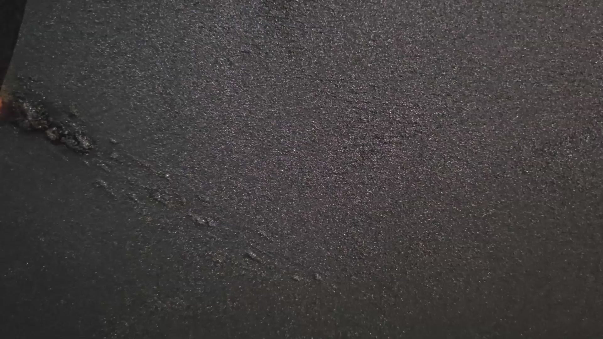 Cinematic close-up video of "Impact of Greed" (2026), a handcrafted illuminated relief artwork by Project X featuring a fractured planetary surface and a glowing molten heart.